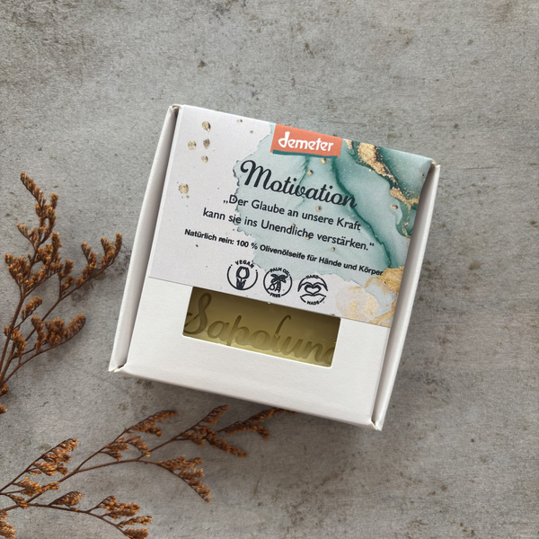 KI generiert: Seifenverpackung mit dem Text: „Motivation. Der Glaube an unsere Kraft kann sie ins Unendliche verstärken.“